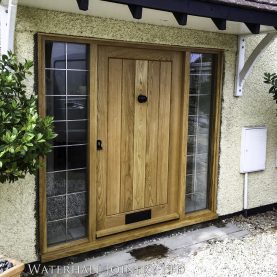 Solid aok front door with leaded double glazed sidelights