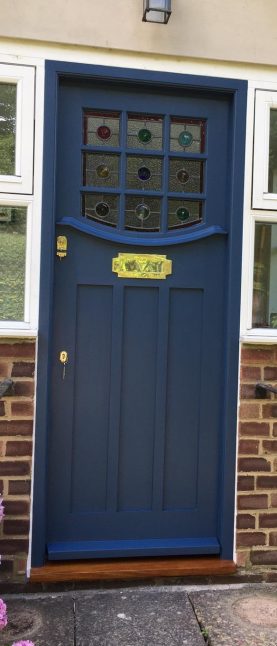 Hardwood front door with 9 panes of decorative leaded glass