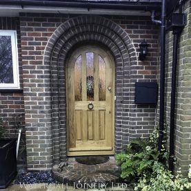Arched topped solid oak glazed door