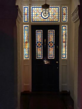 Hardwood front door with side apnels and top lights with decorative leaded lights inside