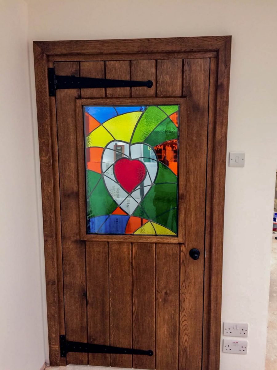 Bespoke Dark Oak Ledged and Braced door with Stained Glass.